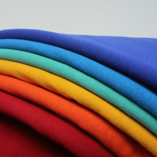 Colorful fabrics laid on top of each other.