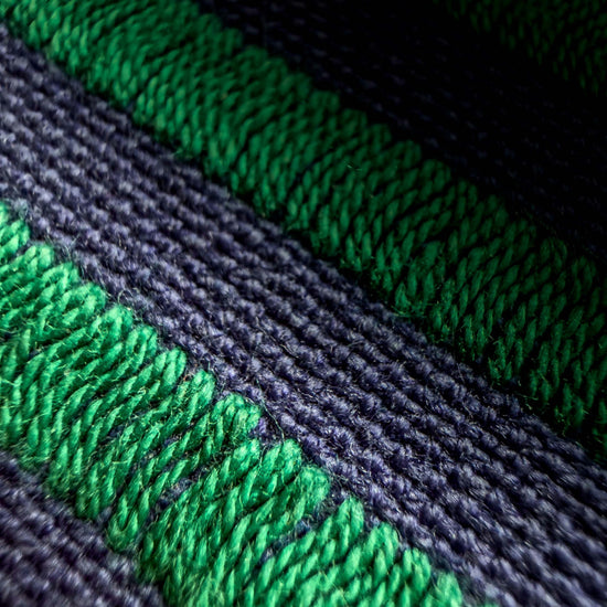Close up of green and black synthetic fibers. 