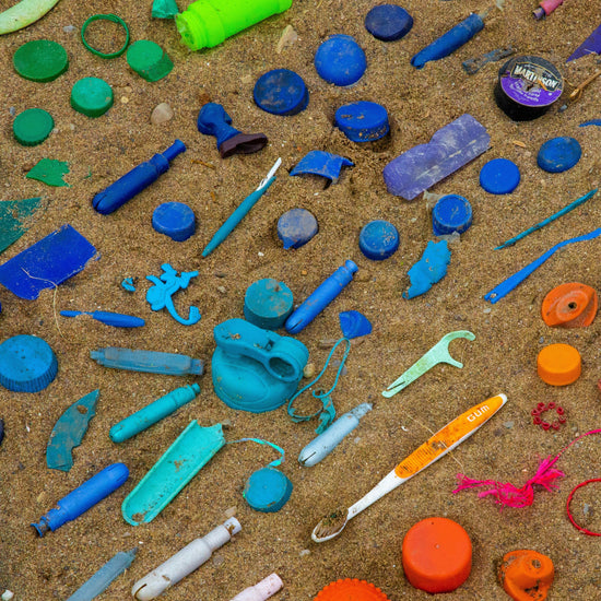 Colorful plastic laid out in sand. 